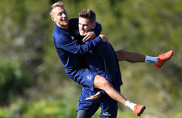 Good vibes: Julian Pollersbeck, celebrating with vice-captain Lewis Holtby in training.