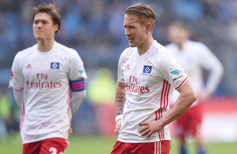 Gotoku Sakai and Lewis Holtby down after defeat.