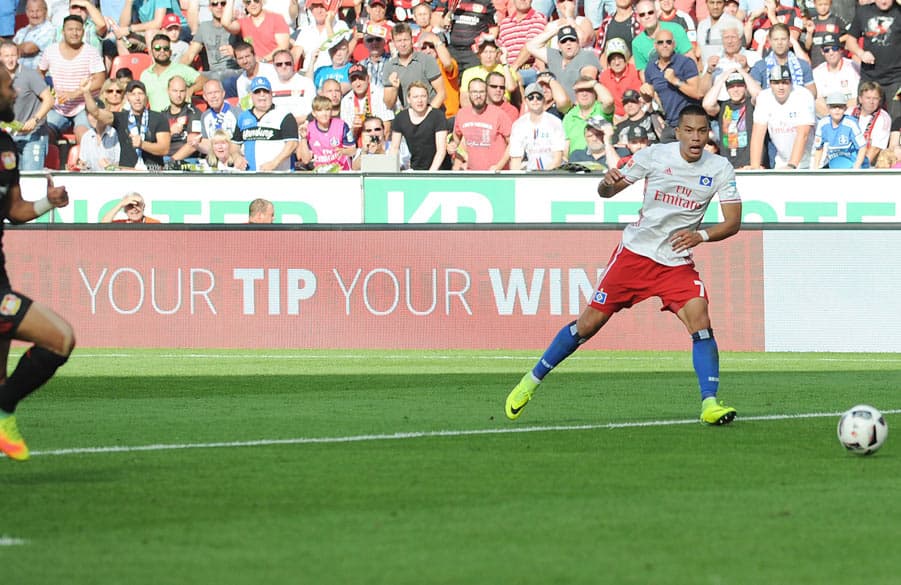 Wood slides the ball into an empty net in Leverkusen.
