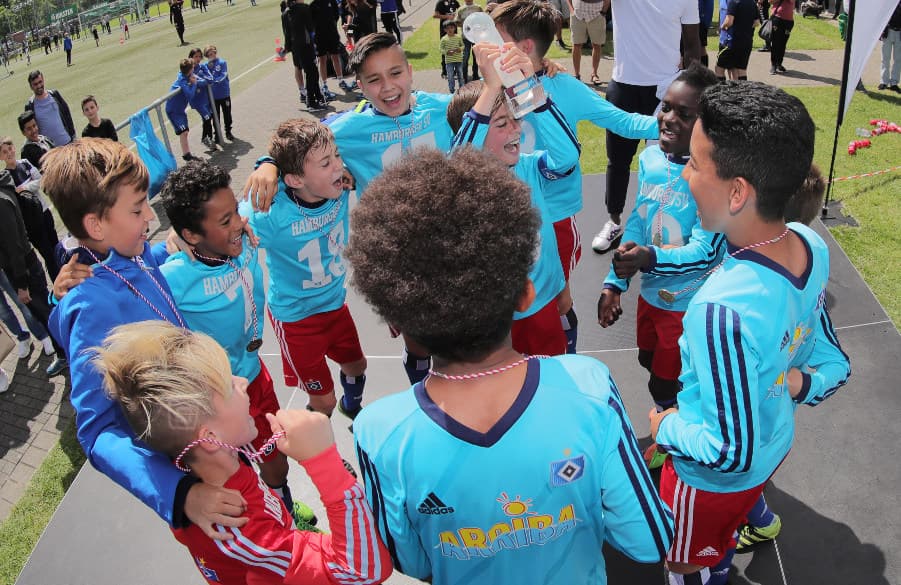 U11-Kapitän Jago Rafi streckt die Pokal-Trophäe in die Luft.