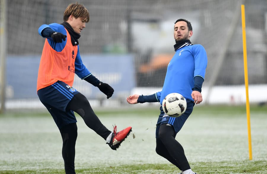 Gotoku Sakai and Mergim Mavraj battle hard in training.