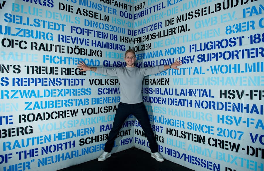 Fan favourite Lewis Holtby posing at the HSV staircase where several names of registered fan clubs have had there names etched in HSV history.