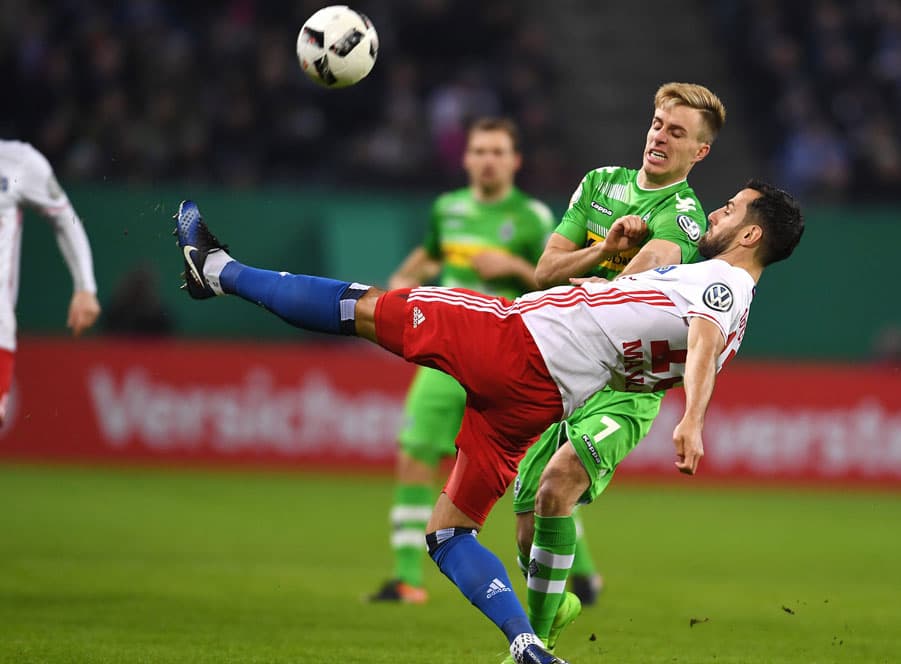Mergim Mavraj tackles Patrick Herrmann.