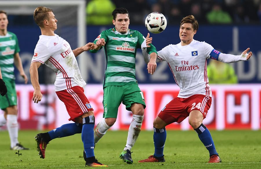 Matthias Ostrzolek and Gotoku Sakai battling in the home game against bitter rivals Werder Bremen.