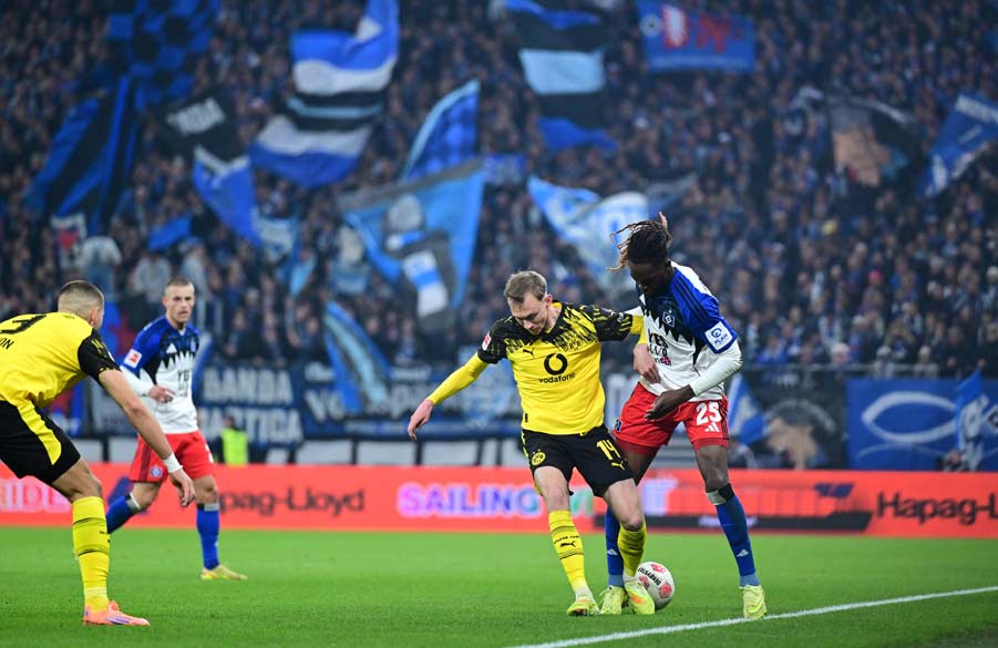 Jordan Torunarigha challenges a Dortmund player for the ball