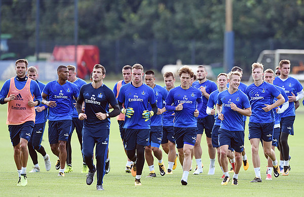 Die Mannschaft läuft in einer Gruppe über den Trainingsplatz.