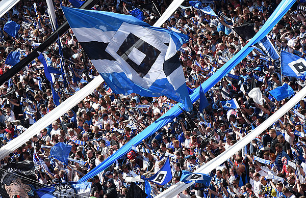 Fans schwenken große HSV-Fahne.