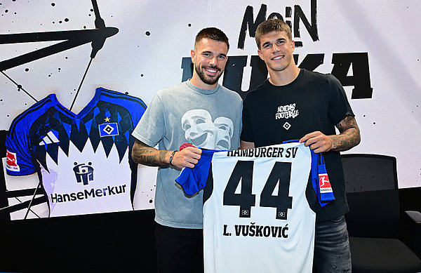 Luka Vuskovic holds up a HSV shirt with the number 44 alongside his brother Mario Luka Vuskovic holds up a HSV shirt with the number 44 alongside his brother Mario