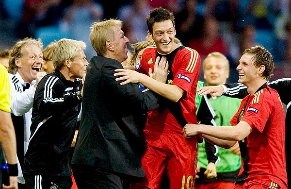 The man who moulded a World Cup winning generation: Horst Hrubesch celebrates European U21 Championship glory together with Mesut Özil.