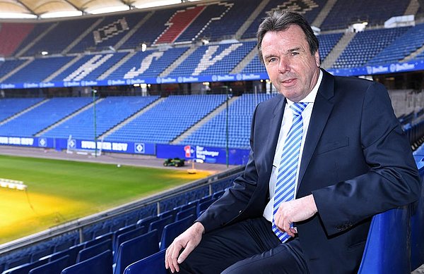 Heribert Bruchhagen sitting in the empty Volksparkstadion.