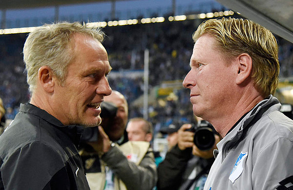 Markus Gisdol and Christian Streich in front of the dug out. 