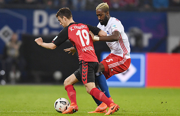 Johan Djourou battles hard against Freiburg.