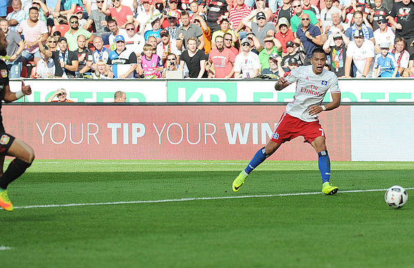Wood slides the ball into an empty net in Leverkusen.