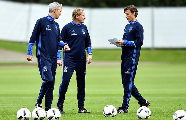 Looking at details: Gisdol and co-trainers Frank Kaspari and Frank Fröhling watch their new charges training.